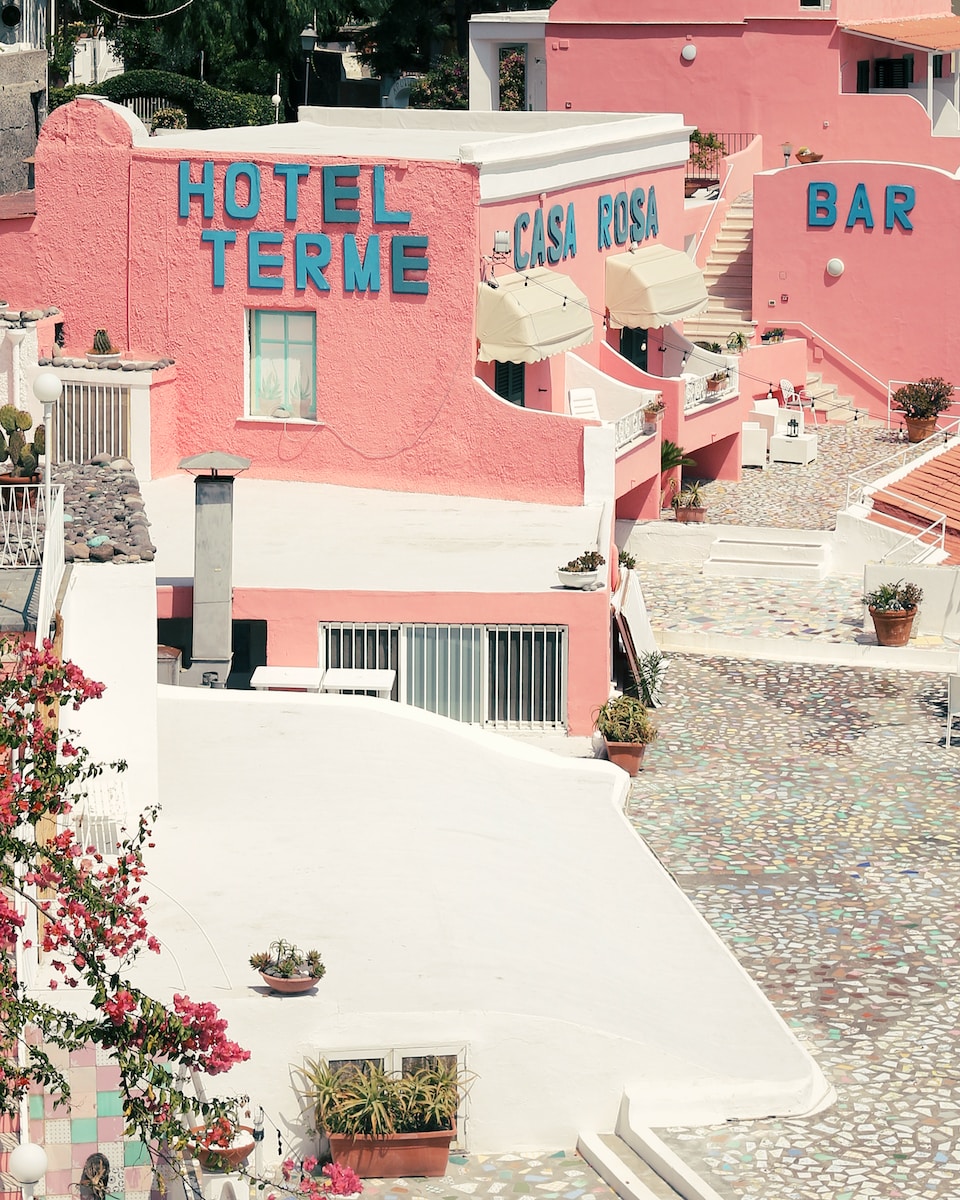 a pink building with a sign that says hotel terme