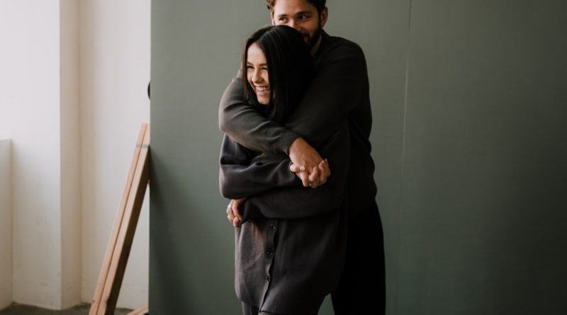 woman in black hoodie and pants sitting on brown wooden chair