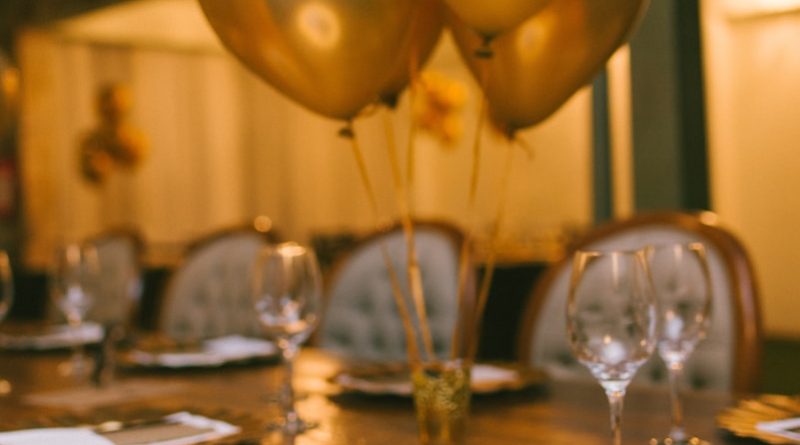 gold balloons on brown wooden table