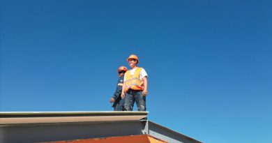 A man standing on top of a skateboard ramp