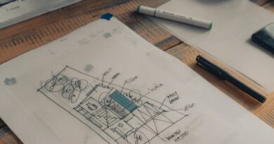 white printer paper beside pen and pen