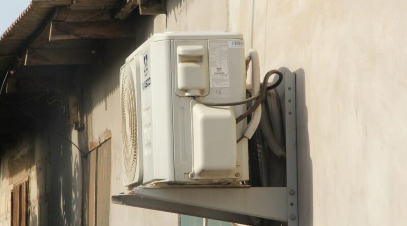 a white phone mounted to the side of a building