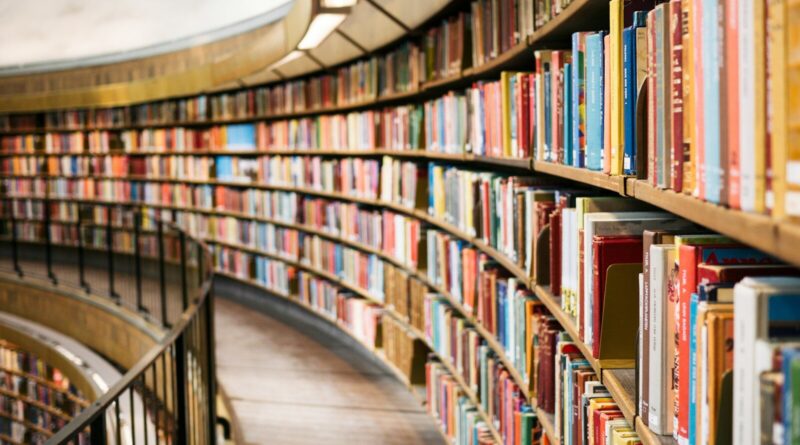books on brown wooden shelf