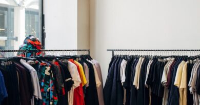 assorted-color clothes hanging on metal racks