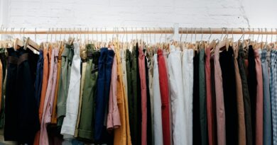 assorted-color clothes lot hanging on wooden wall rack