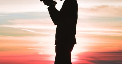 silhouette photo of man holding camera
