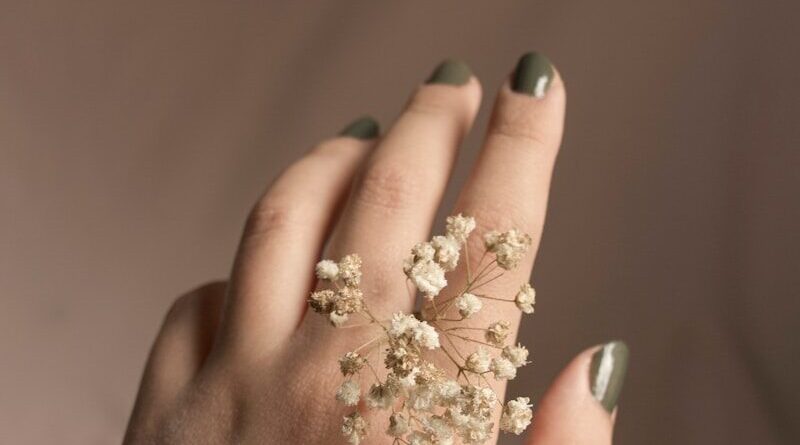 person with white flower on hand