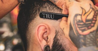 man in black shirt with tattoo on his left arm