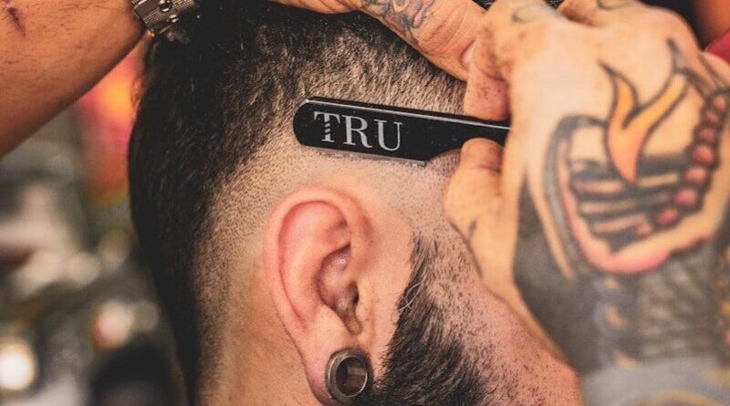man in black shirt with tattoo on his left arm