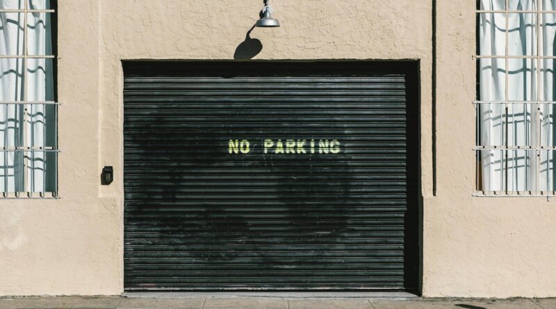 black metal roll-up door with no parking print